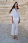 nisex white linen shirt styled with matching linen pants, ideal for hot weather