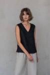 Front view of the V-Neck Linen Sleeveless Blouse in black, featuring a minimalist design and clean silhouette