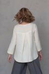 Back view of the Linen Blouse with Back Pleat ROSE, highlighting the unique pleated detail and smooth drape of natural linen