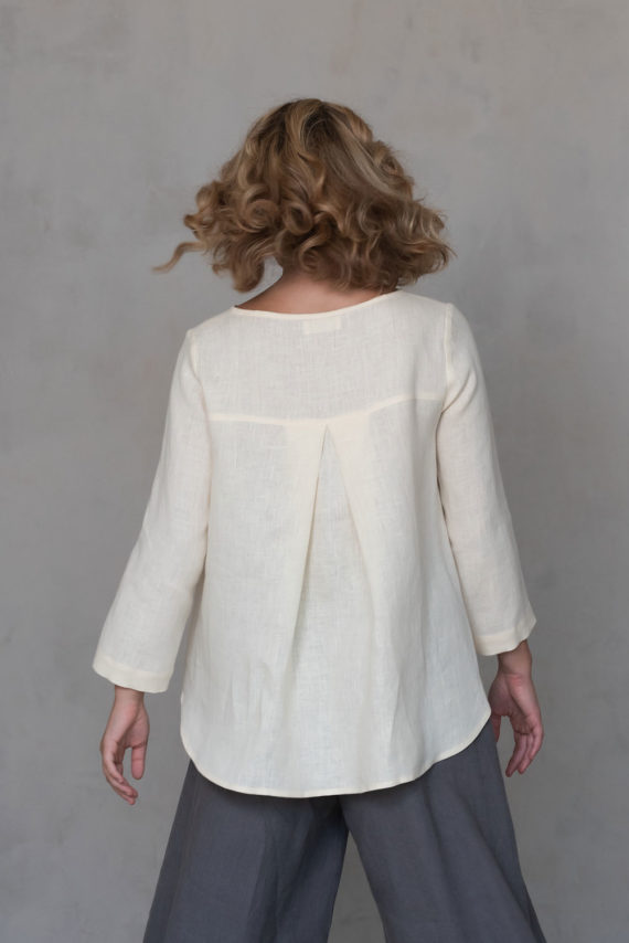 Back view of the Linen Blouse with Back Pleat ROSE, highlighting the unique pleated detail and smooth drape of natural linen