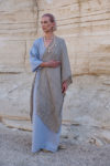 Woman in the natural Galabeya dress enjoying a minimalist and elegant style.