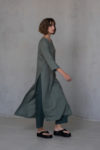 The Linen Tunic Dress KAYLO shown in motion, highlighting its flowy fit and functional high side slits.