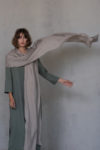 Versatile natural flax linen scarf wrapped around the shoulders for a chic appearance