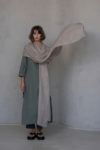 Long gauze linen scarf in a natural flax tone styled as a cozy wrap