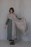 Soft natural flax gauze scarf paired with a long green dress for a timeless look.