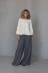 Model wearing the Linen Blouse with Back Pleat ROSE, styled with palazzo pants for effortless elegance