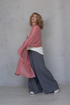 Coral Gauze Linen Scarf styled loosely as a summer wrap, perfect for warm-weather layering.