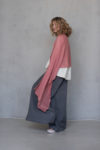 Coral Gauze Linen Scarf wrapped around the shoulders, showcasing its vibrant color and soft texture.