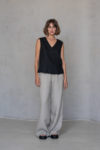 V-Neck Linen Sleeveless Blouse paired with tailored trousers, offering a versatile look for both casual and formal occasions