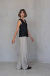 Side view of the sleeveless linen top with a V-neckline, highlighting its relaxed drape and breathable texture