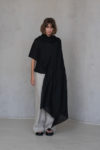 Black Gauze Linen Scarf draped over one shoulder, showcasing its lightweight texture and elegant black hue.