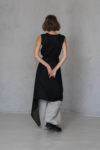 Back view of a black linen wrap tied at the waist, styled as a skirt overlay.