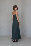 Side view of the Bias-Cut Linen Dress VERED in dark green, showcasing its graceful drape and timeless design.