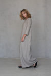 Side profile of RITA A-line winter dress showcasing its fitted sleeves and flowing silhouette.