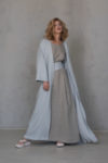 Model wearing the URSA Long Linen Abaya, showing the open-front kaftan design and relaxed fit, perfect for layering