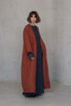 Side view of the KRIS Long Linen Coat, highlighting the relaxed fit and long sleeves for cooler days