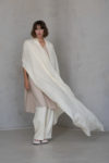 Unisex Ivory Gauze Linen Scarf draped over shoulders, showcasing its lightweight texture, breathable fabric, and timeless color