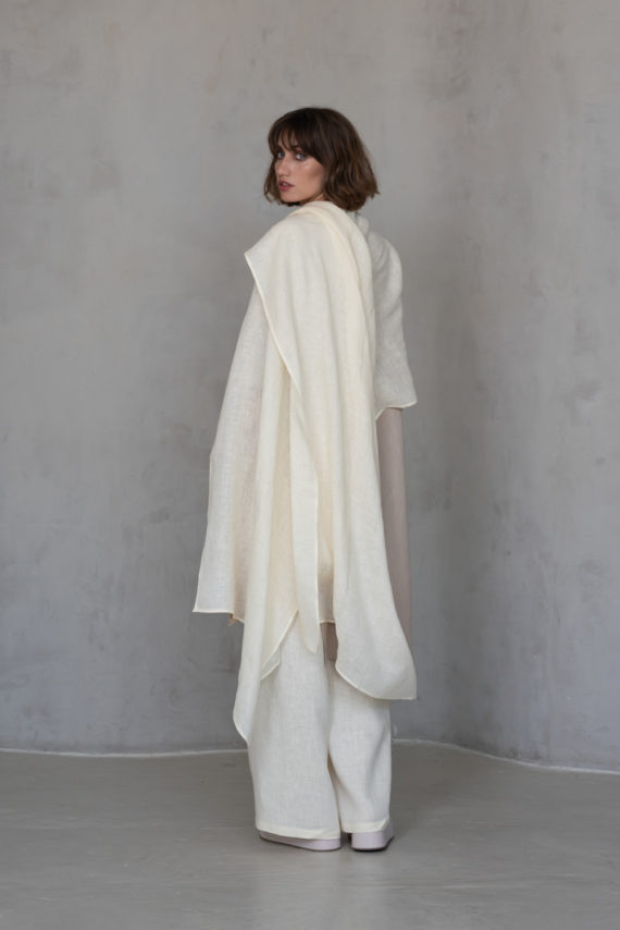 Unisex Ivory Gauze Linen Scarf worn as a shawl, highlighting its incredible fabric and soft, flowing drape.