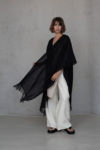 One-size-fits-all fringed linen cover in black, adding a stylish boho touch