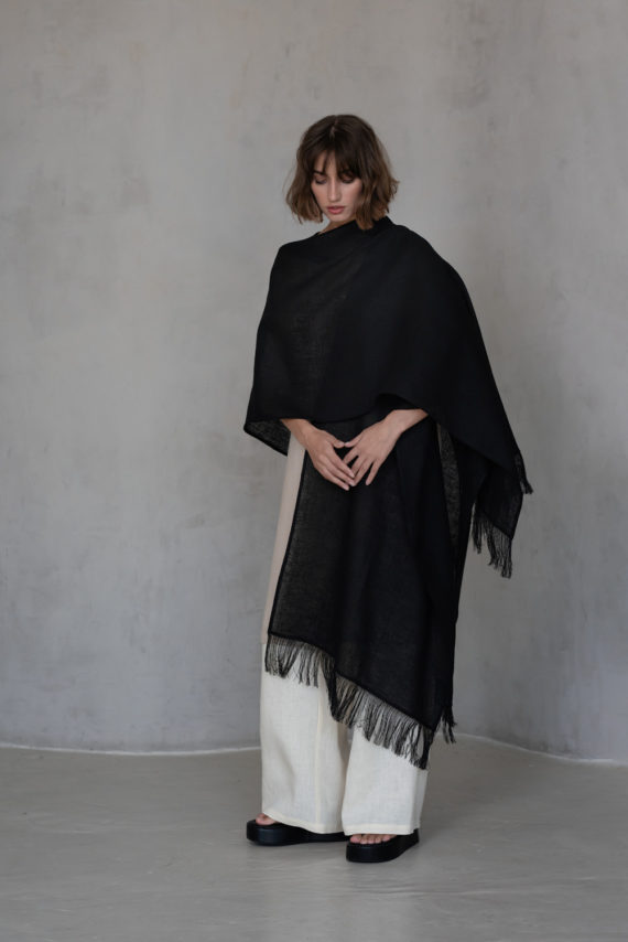 Fringed edge black linen cover styled for a versatile boho-inspired look