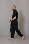 Side view of the men’s linen jumpsuit SIGMA, highlighting the relaxed fit, breathable linen fabric, side pockets, and modern design.