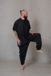 Men’s linen jumpsuit SIGMA in black, captured in motion to highlight its flexible fit, breathable fabric, and modern design, perfect for ease of movement and everyday comfort