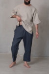 Close-up of men’s cropped pants ZEN in natural flax color, focusing on the elastic waistband and practical pocket design