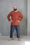 Shantima’s Long-Sleeve Linen Top Aviv in natural flax color, showcasing a relaxed fit and classic round neckline on man