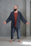 A relaxed pose of the model in the men's open-front linen jacket, highlighting its breathable and comfortable design.