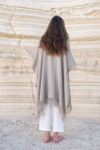 Back view of a natural flax Linen Jacket with Fringes, showing its loose fit and elegant fringe details.