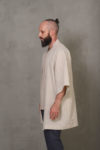 Side view of the linen kimono jacket on a man, capturing its elegant drape and versatile styling.